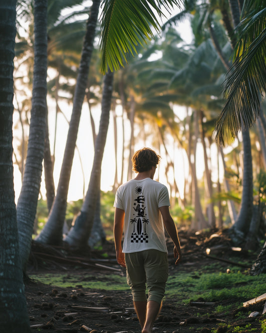 The Sun Bird tee — sun, seabird, goddess in prayer and surfboard stacked in a single black column, printed in black on white cotton